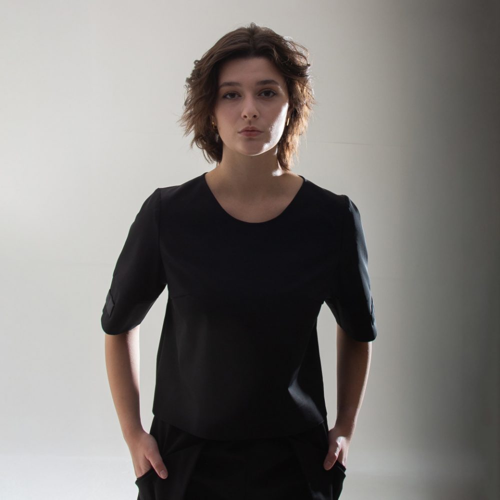 top t shirt with small openings for scissors and hair clips located on the sleeve, designed for women hairstylists