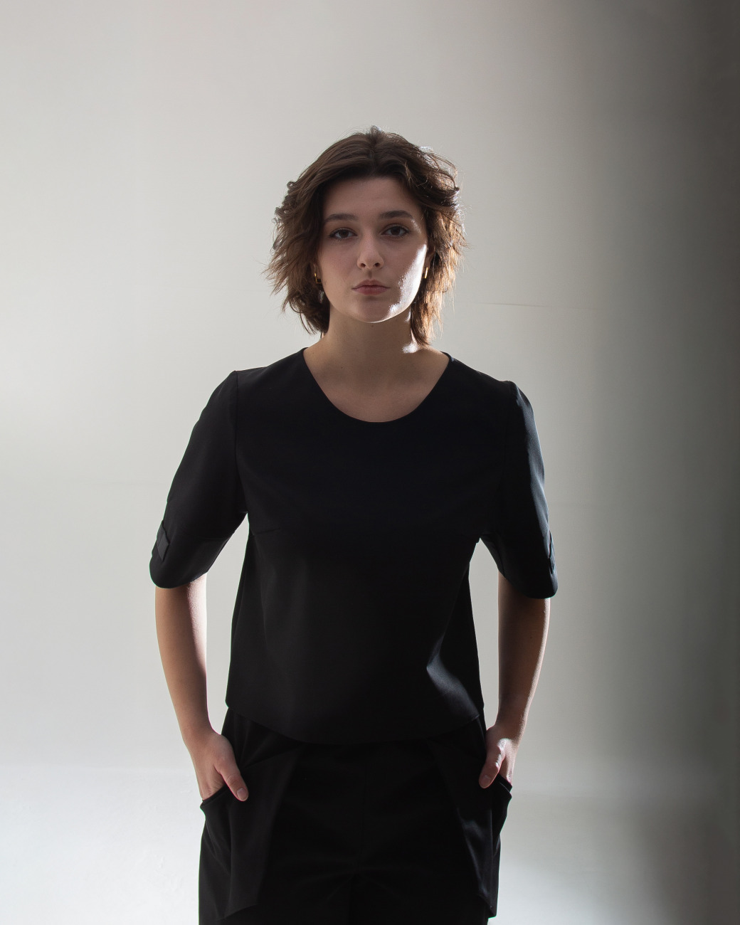 top t shirt with small openings for scissors and hair clips located on the sleeve, designed for women hairstylists