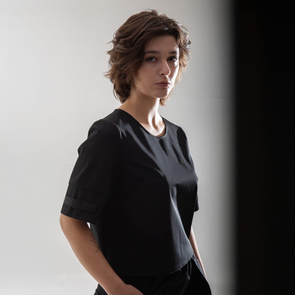 top t shirt with small openings for scissors and hair clips located on the sleeve, designed for women hairstylists