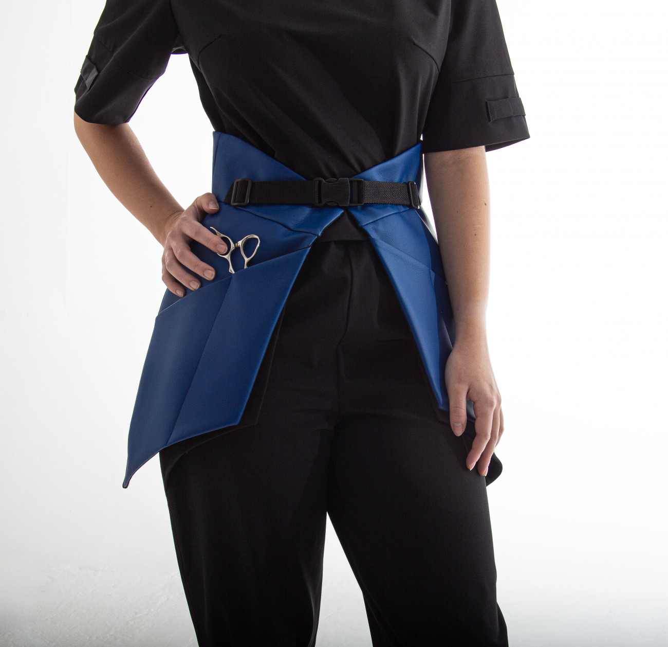 top t shirt with small openings for scissors and hair clips located on the sleeve, designed for women hairstylists