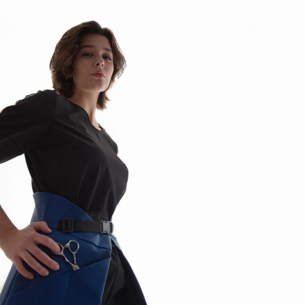 top t shirt with small openings for scissors and hair clips located on the sleeve, designed for women hairstylists